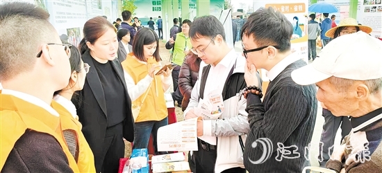保險(xiǎn)行業(yè)工作人員向群眾普及金融知識(shí)。